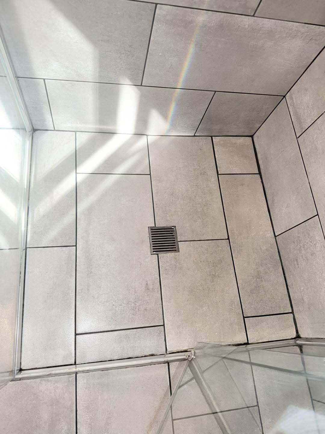Real FirstChoice cleaning job showing a tiled shower floor and glass screen